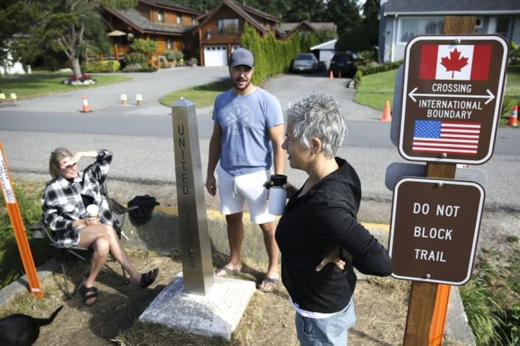 In August 2021, Chelsea Perry (L) and husband Garrick Perry of Calgary, Alberta, meet with friend Alison Gallant of Bellingham, Washington, at the US-Canada border, as it opened to fully-vaccinated Americans while Canadians cannot yet enter the US for non