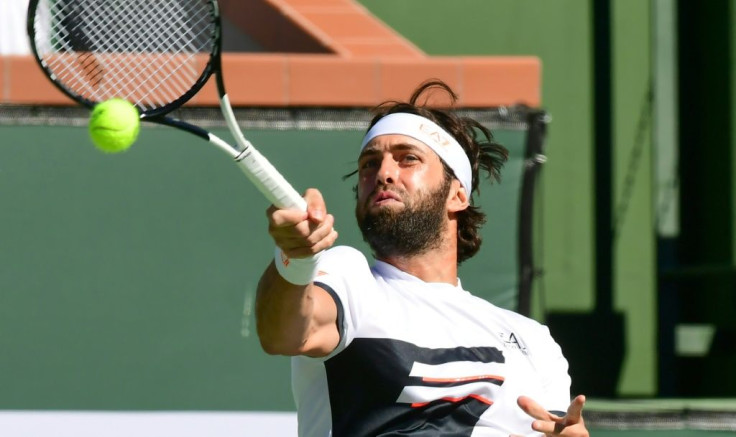 Nikoloz Basilashvili of Georgia hits a forehand return to Stefanos Tsitsipas of Greece in their quarter-final match at the Indian Wells tennis tournament in the California desert