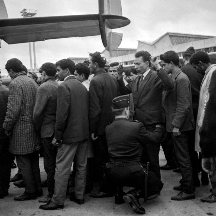 Algerians arrested during the demonstration in Paris on October 17, 1961  are searched before boarding a plane bound for Algeria