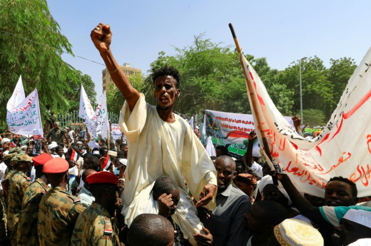 Sudanese protesters take part in a rally demanding the dissolution of the transitional government, outside the presidential palace in Khartoum on Saturday