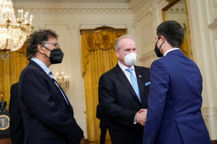 Transportation Secretary Pete Buttigieg speaks with Mario Cordero, executive director of the Port Long Beach, and Gene Seroka, executive director of the Port of Los Angeles, at a White House meeting this week