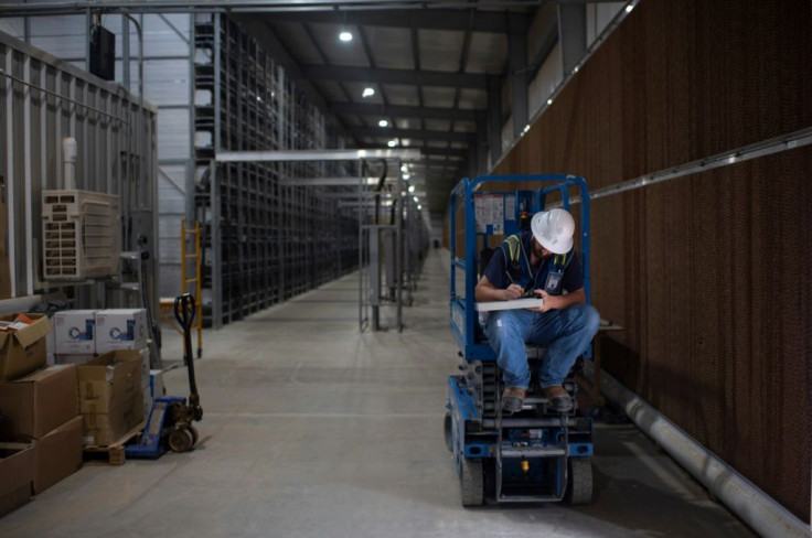 A worker fills out a form at the Whinstone US Bitcoin mining facility in Rockdale, Texas, on October 10, 2021