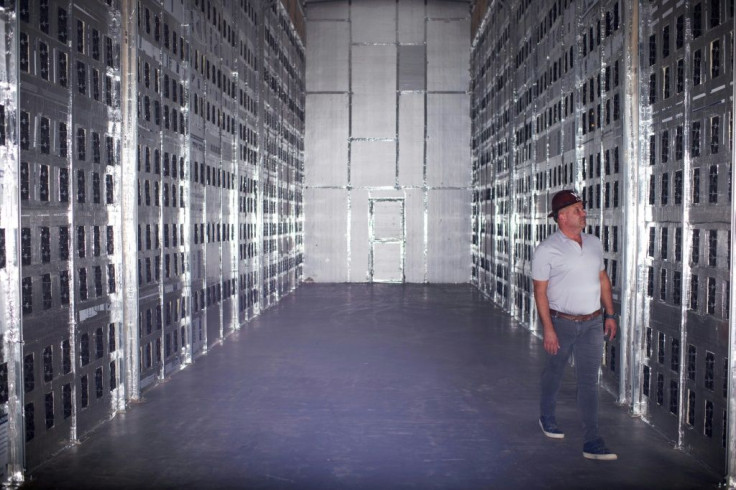 Whinstone CEO Chad Harris poses for a portrait in a room with bitcoin mining machines during a tour at the Whinstone US Bitcoin mining facility in Rockdale, Texas, on October 10, 2021