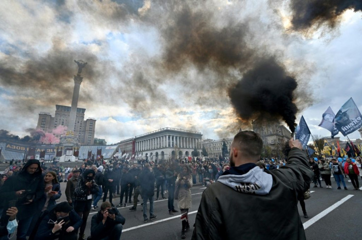 Activists burn flares during a march of nationalists movements in Kiev on October 14, 2021, a day considered as symbolic for Ukrainian nationalists and the Defender of Ukraine Day