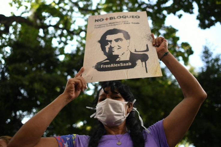 A woman holds a sign with the image of Colombian businessman Alex Saab, who was extradited to the United States, during a demonstration demanding his release in Caracas, Venezuela on October 17, 2021