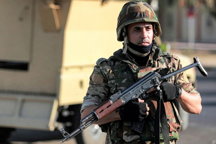 A member of Hashed al-Shaabi stands guard during an election rally for the "Asaib Ahl al-Haq" movement in the Iraqi capital Baghdad