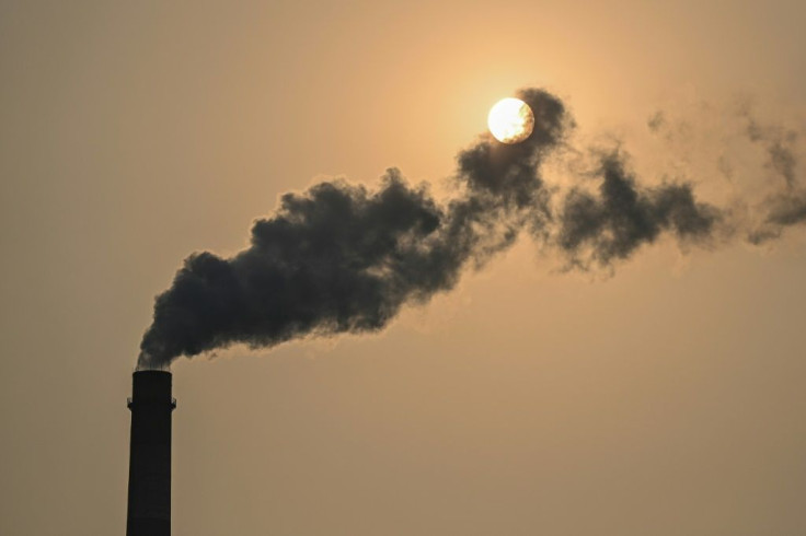 Smokestacks belch noxious fumes into the air from a massive coal-fired power plant on the Indonesian coast, a stark illustration of Asia's addiction to the fossil fuel which is threatening climate targets