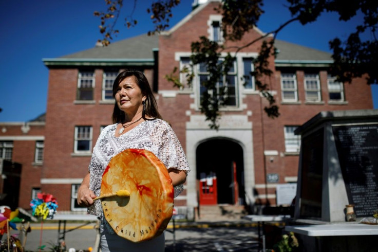 Chief Rosanne Casimir, of Tk'emlups te Secwepemc poses at the site of a makeshift memorial at the former Kamloops Indian Residential School in Kamloops, Canada