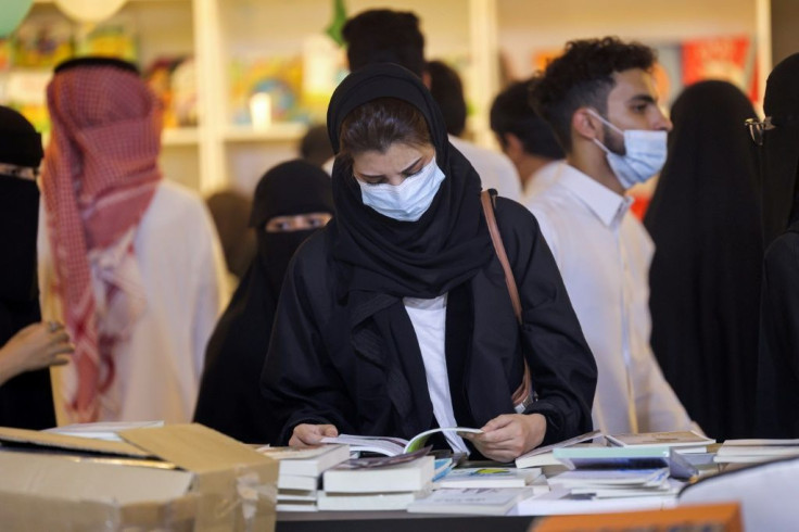 A woman browses a volume at the book fair -- since Mohammed bin Salman was appointed crown prince in 2017, the kingdom has undergone economic, religious and social reforms