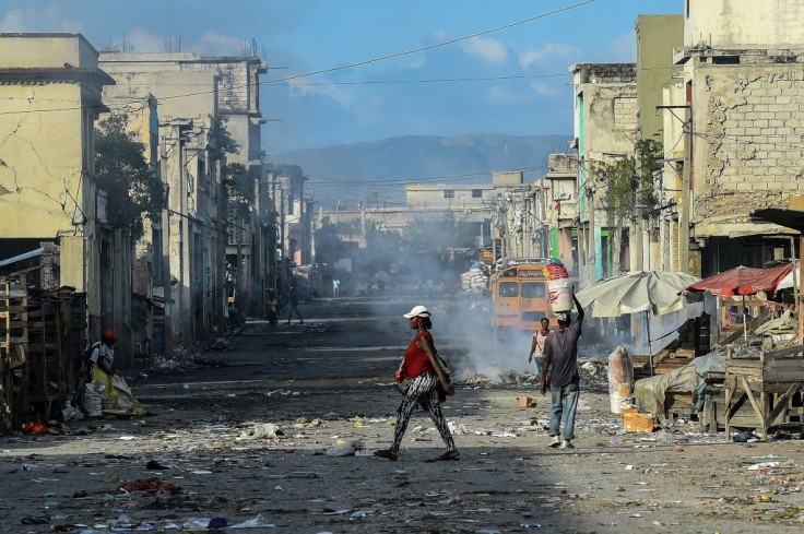 In this file photo taken on December 20, 2019, people walk on a deserted road in Port-au-Prince, Haiti