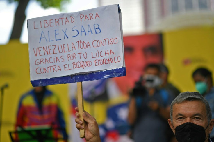 A man holds a sign in support of Alex Saab at a demonstration demanding his release in Caracas, on October 17, 2021