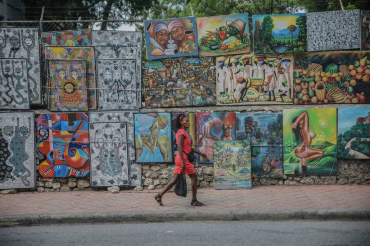 A woman walks in the deserted street in Port-au-Prince on October 18, 2021