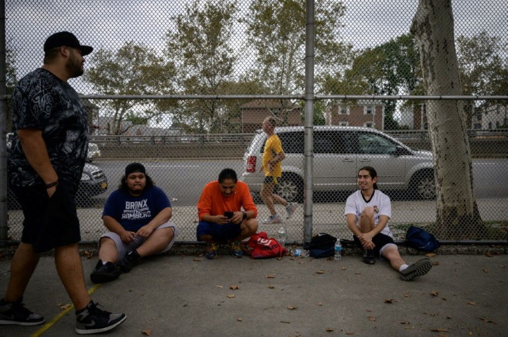 A group of men pause between games on a handball court as Stutisheel Lebedyev (C) of Ukraine competes in the 'Self-Transcendence 3100 Mile Race', in Queens, New York