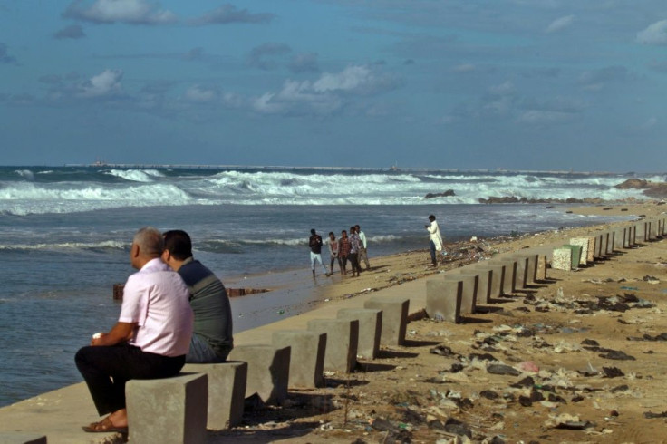 People gather along the beach in Libya's eastern city of Benghazi, on October 15, 2021.