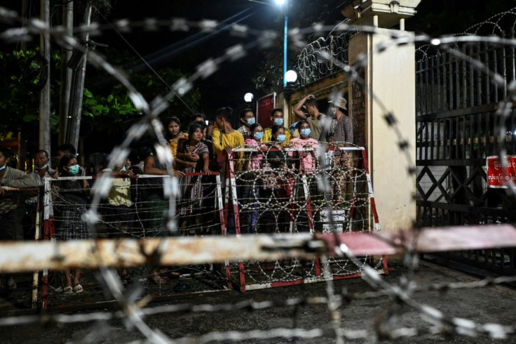 People wait outside the Insein Prison in Yangon as authorities announced more than 5,000 people jailed for protesting against a February coup would be released