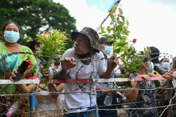 Some of those waiting outside the prison were carrying flowers and placards bearing the names of their relatives