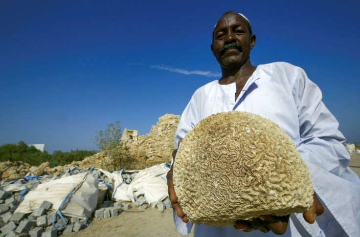A man carries coral on the island of Suakin in eastern Sudan