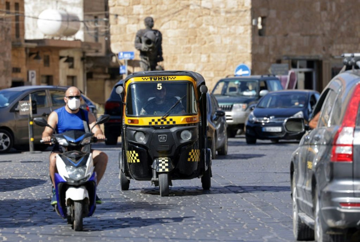 A tuk-tuk taxi drives on a street in the Lebanese city of Batroun north of the capital Beirut