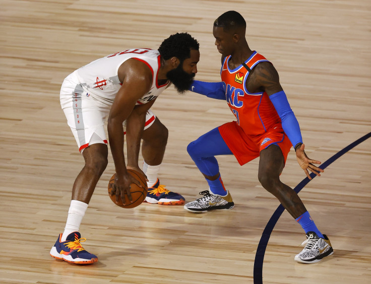 Dennis Schroder #17 of the Oklahoma City Thunder defends against James Harden #13 of the Houston Rockets