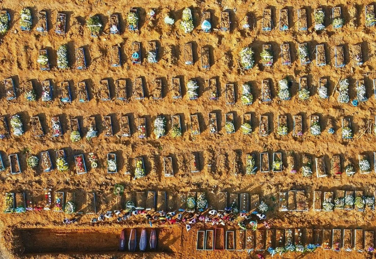 Coffins being buried in an area where new graves have been dug at the Parque Taruma cemetery in Manaus, Amazonas State