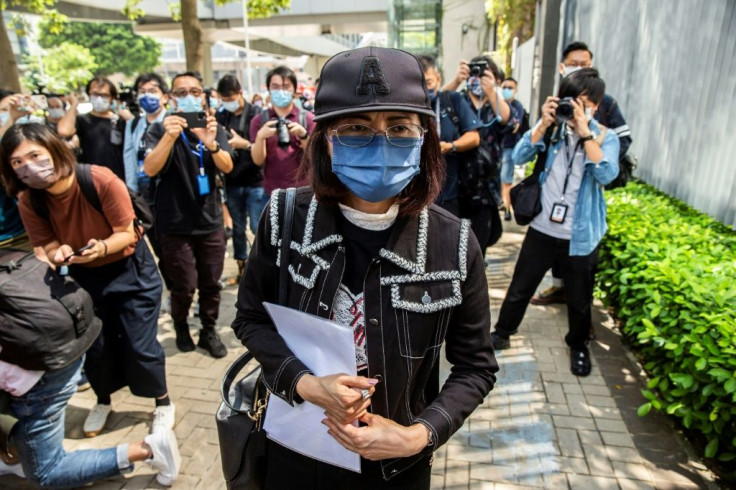 The mother of Poon Hiu-wing (C), a 19-year-old woman who was murdered by her boyfriend during a visit to Taiwan in 2018, leaves after speaking to the media in Hong Kong