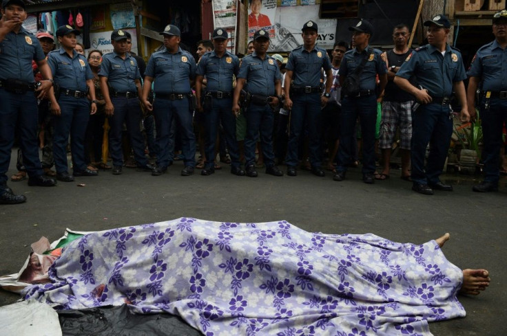 Police gather around the body of a suspect killed during an anti-drug operation in Manila in 2016