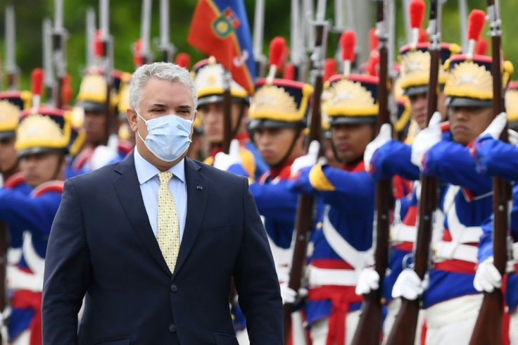 Colombia's President Ivan Duque reviews an honor guard during a welcome ceremony at Planalto Palace in Brasilia