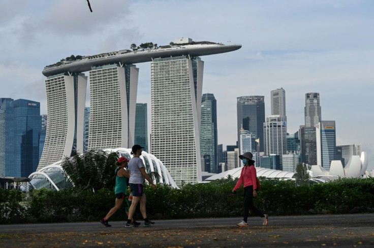 Singapore's government has warned that its healthcare system risked being "overwhelmed" by surging coronavirus infections