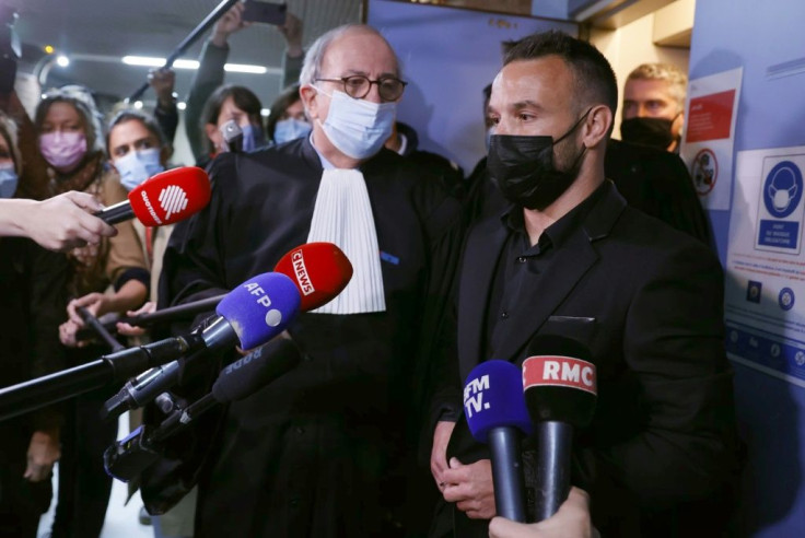 French football player Mathieu Valbuena (R), involved in a 'sex tape case', addresses media representatives next to lawyer Paul Albert Iweins (C) inside a court