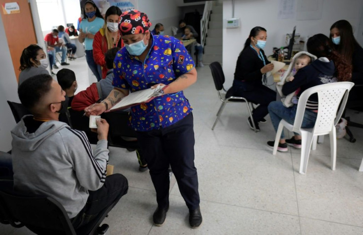 Venezuelan migrants wait to be inoculated against Covid-19 with the Johnson & Johnson vaccine in Bogota on October 11, 2021
