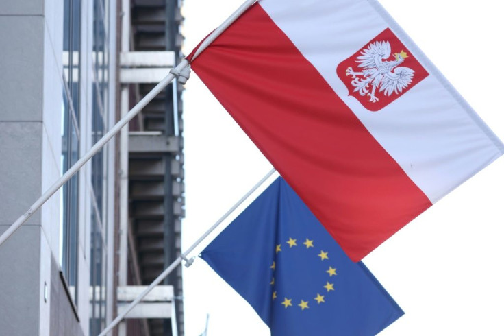 The Polish and EU flags fly together outside the Polish embassy in Brussels but relations between the two are at a low