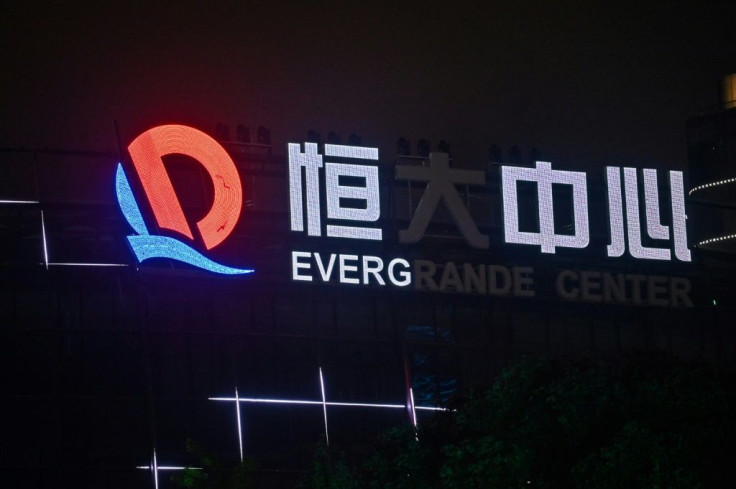 China Evergrande dived in Hong Kong and analysts warned it will likely suffer further losses after the sale of its property services unit collapsed