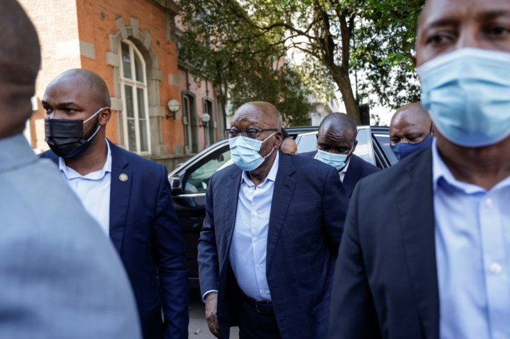 Zuma stepped briskly out of his vehicle and up to the building's entrance surrounded by security personnel
