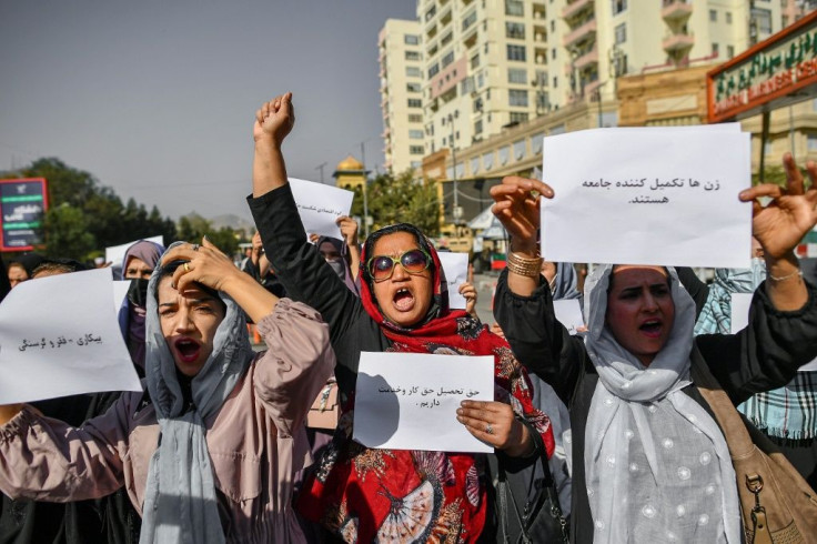 Afghan women chant slogans and hold placards in Kabul, where the ruling Taliban violently cracked down on media coverage of a women's rights protest