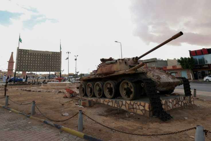 A memorial commemorating pro-Kadhafi Libyans killed in post-2011 confrontations behind a damaged tank, in the city of Bani Walid, about 180 kilometers southeast of the capital
