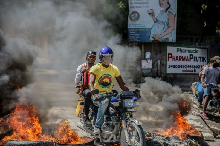 Blazing barricades burn after being set on fire by groups of motorcycle taxi drivers in Port-au-Prince, on October 21, 2021, to protest against fuel shortages.