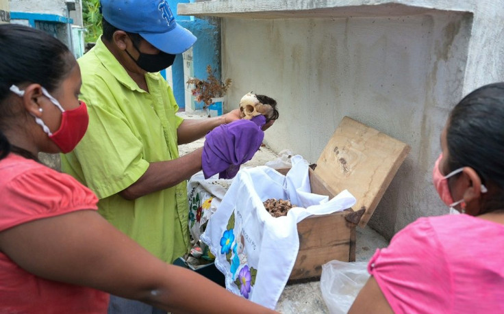 After the bones are cleaned, the shroud is changed and the remains are returned to the grave