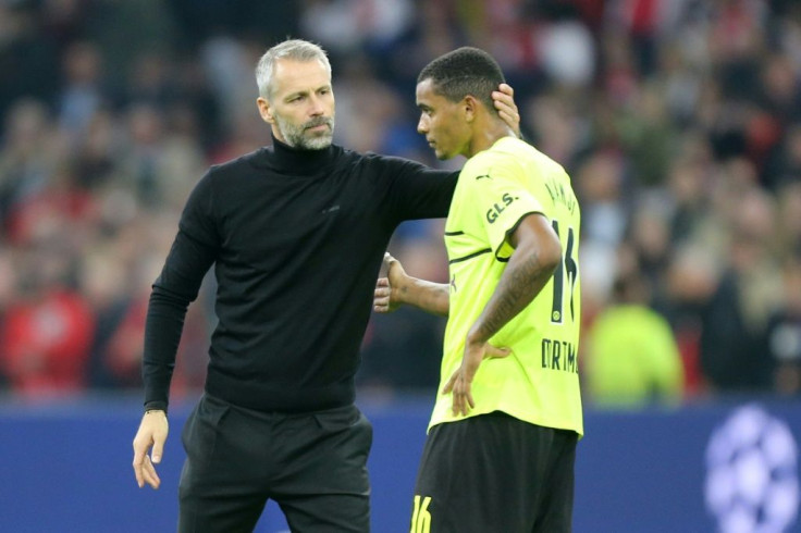 Dortmund coach Marco Rose comforts defender Manuel Akanji after the 4-0 drubbing at Ajax