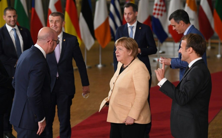 Merkel in her light jacket stood out from the dark suits of her counterparts in a summit group photo