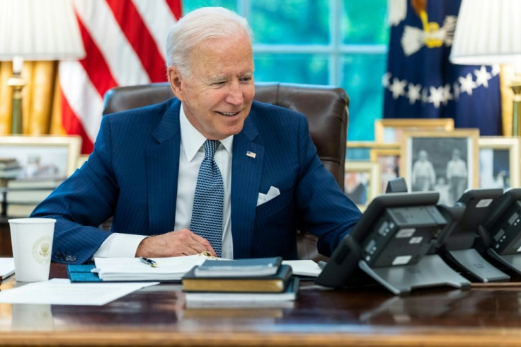 US President Joe Biden talks on the phone with French President Emmanuel Macron on September 22, 2021, in the Oval Office of the White House