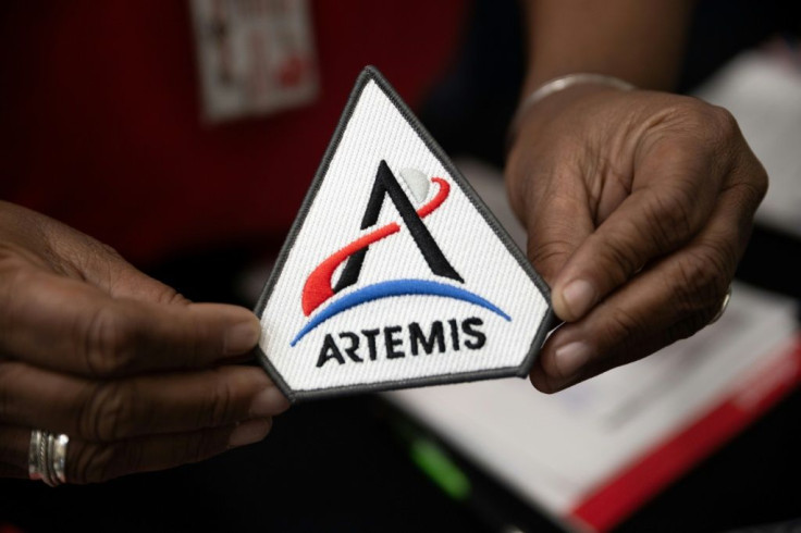 A NASA employee holds the official Artemis mission patch at NASA Plum Brook Station in Sandusky, Ohio