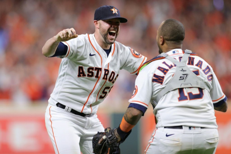 Houston closer Ryan Pressly celebrates with catcher Martin Maldonado after the Astros clinch a 5-0 victory over the Boston Red Sox to seal their World Series place