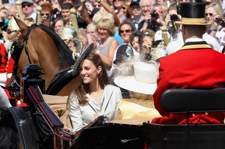 Kate rides a chariot with members of the Royal Family