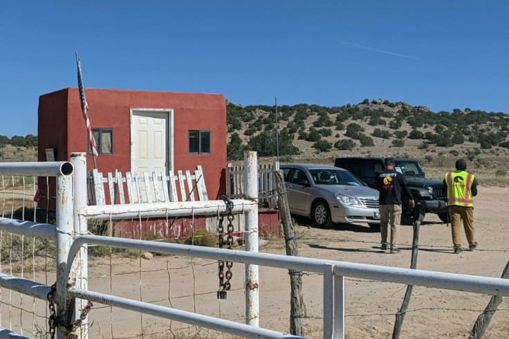 Security guards stand at the entrance of Bonanza Creek Ranch in Santa Fe, New Mexico on October 22, 2021