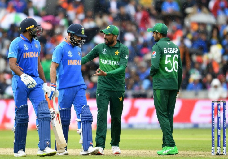 Rivals: Pakistan's Mohammad Amir and Babar Azam speak with India captain Virat Kohli and Vijay Shankar at the 2019 World Cup in Manchester