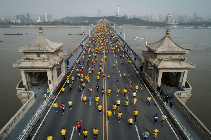 Wuhan marathon runners cross the Yangtze River bridge in 2018. This year's event was postponed at short notice because of Covid fears