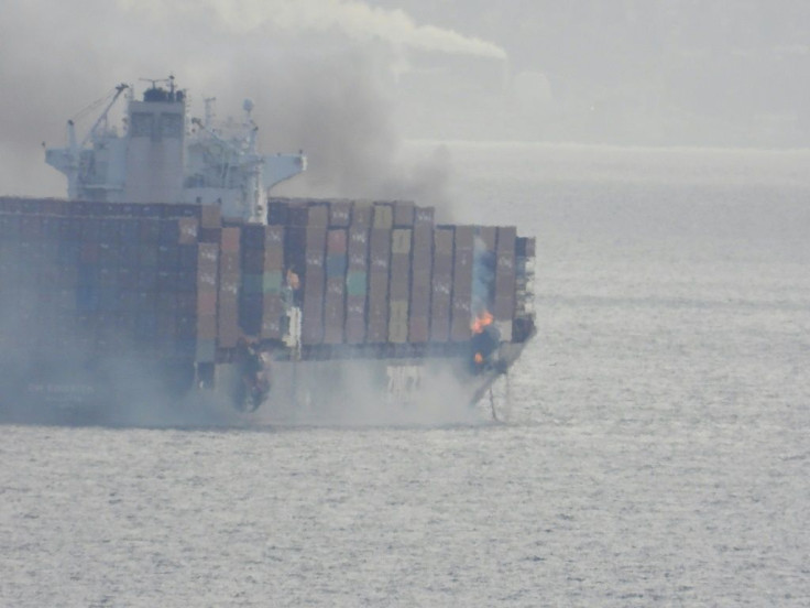 In this photo taken by Gerald Graham and received by AFP on October 24, 2021, smoke is seen rising from the side of the container ship Zim Kingston off Canada's Pacific coast
