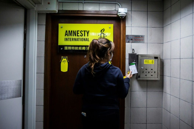 An employee enters one of Amnesty's Hong Kong offices on Monday