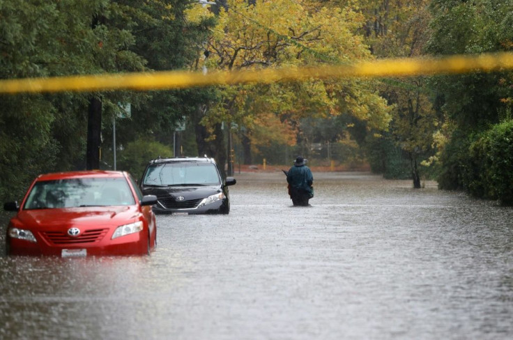 A pedestrian walks on a flooded street on October 24, 2021 in Kentfield, California