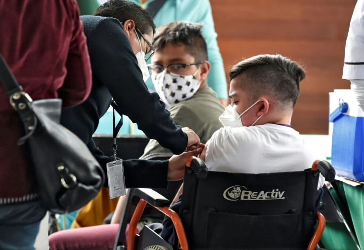 A minor in Mexico City is inoculated with the Pfizer-BioNtech vaccine against Covid-19 as part of the capital city's plan to vaccinate at-risk youths